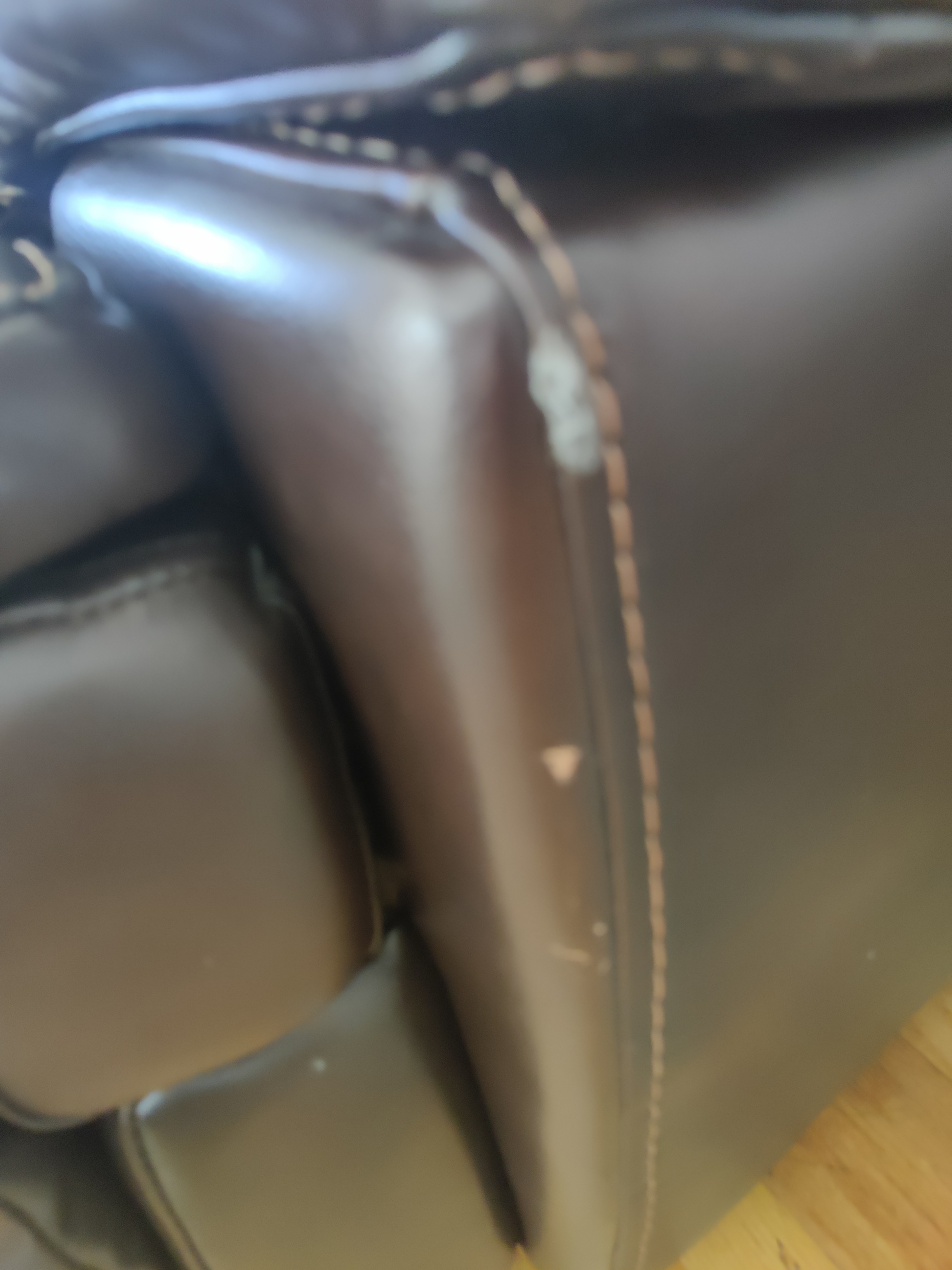 Damaged leather sofa before repair